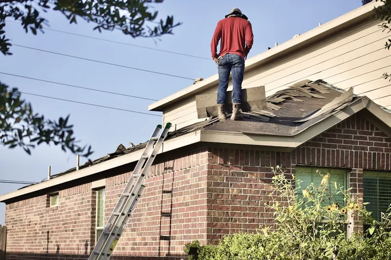 Professional roofer working on a residential roof in Lackland AFB